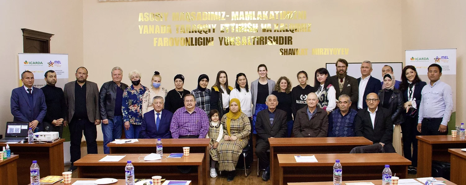 The full ICARDA and HiveTracks team assembled in a conference room in Tashkent, with ICARDA and MEL banners visible